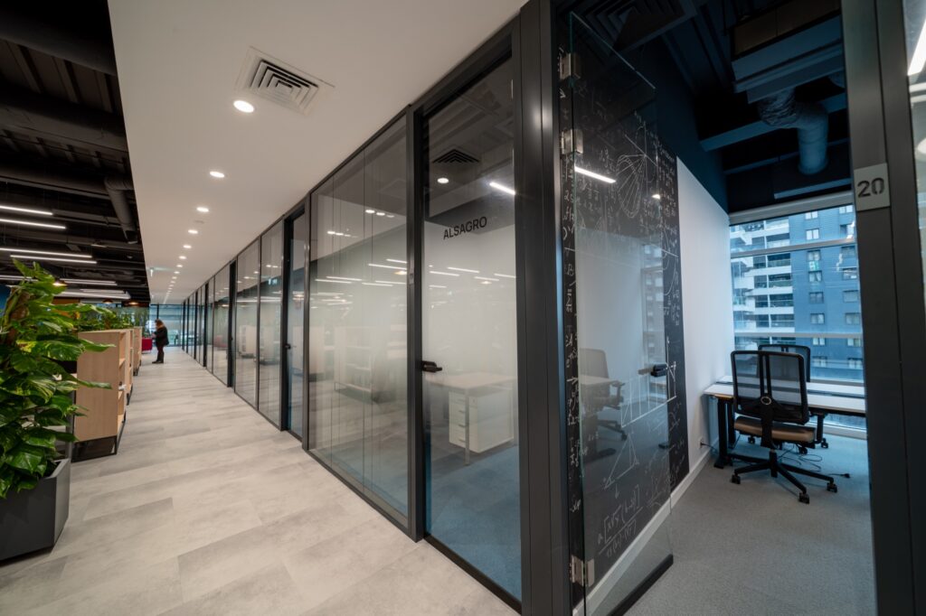 A corridor of custom-branded managed company offices at Supertree